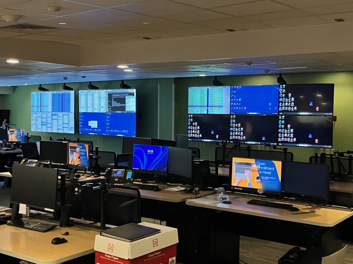 Operations and dispatch center with multi-display video walls above operator consoles, by Enlightened Audiovisual